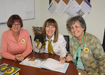 Schmitty The Weather Dog paw-to-graphs books for Principal Gayle Hills & STEM Coach Dr Jan Mooney-Frank
