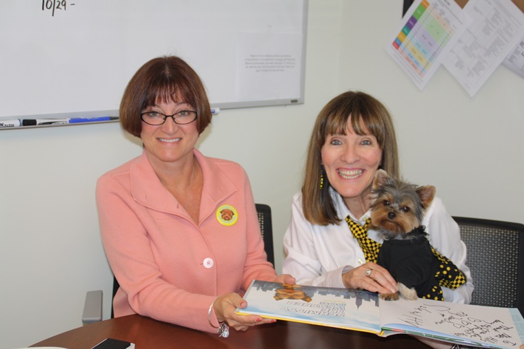 Top Dog Principal Gayle Hill looks on while Author Elly & I paw-to-graph a book for the school library. 